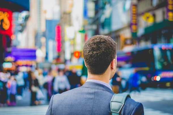 Person walking through a city, heading to a job or job interview.